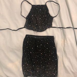 Black mesh miniskirt and top with rhinestone detail.